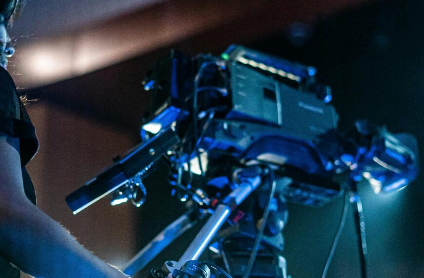 Crop person using professional camera to shoot video of music show during performance